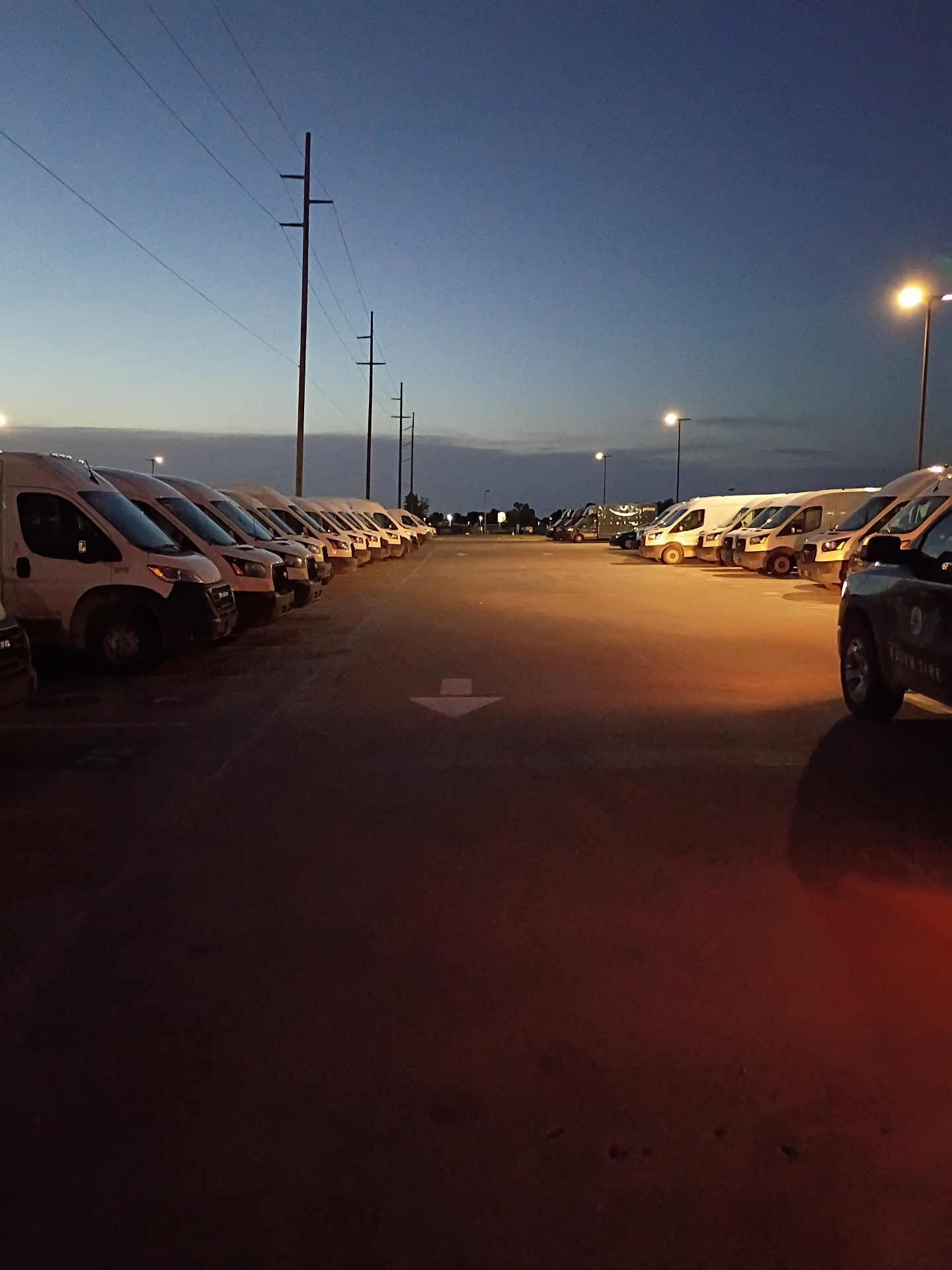 Fleet of vans staged for tire checks at dusk